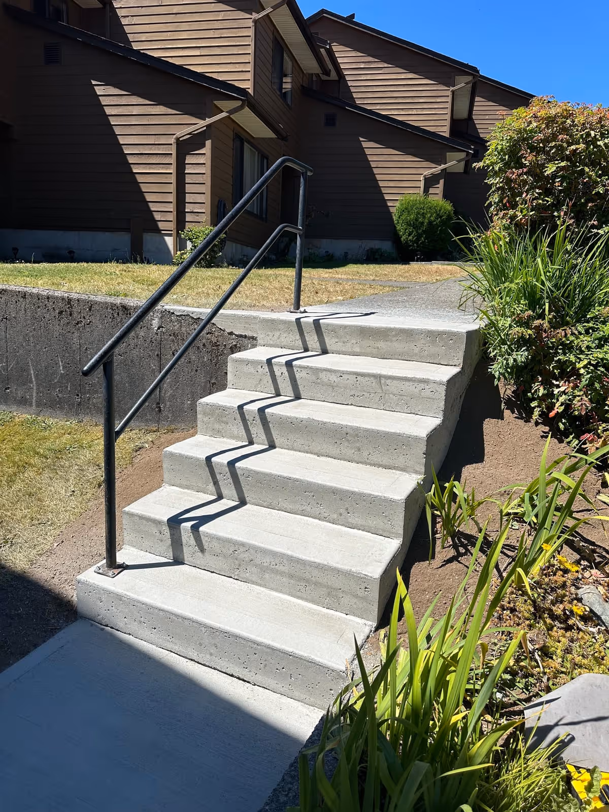 Concrete steps with a metal railing