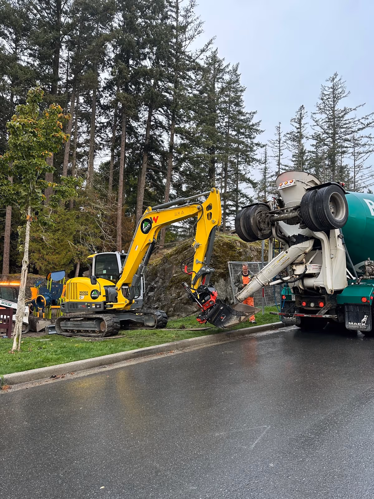 Excavator working alongside a cement truck