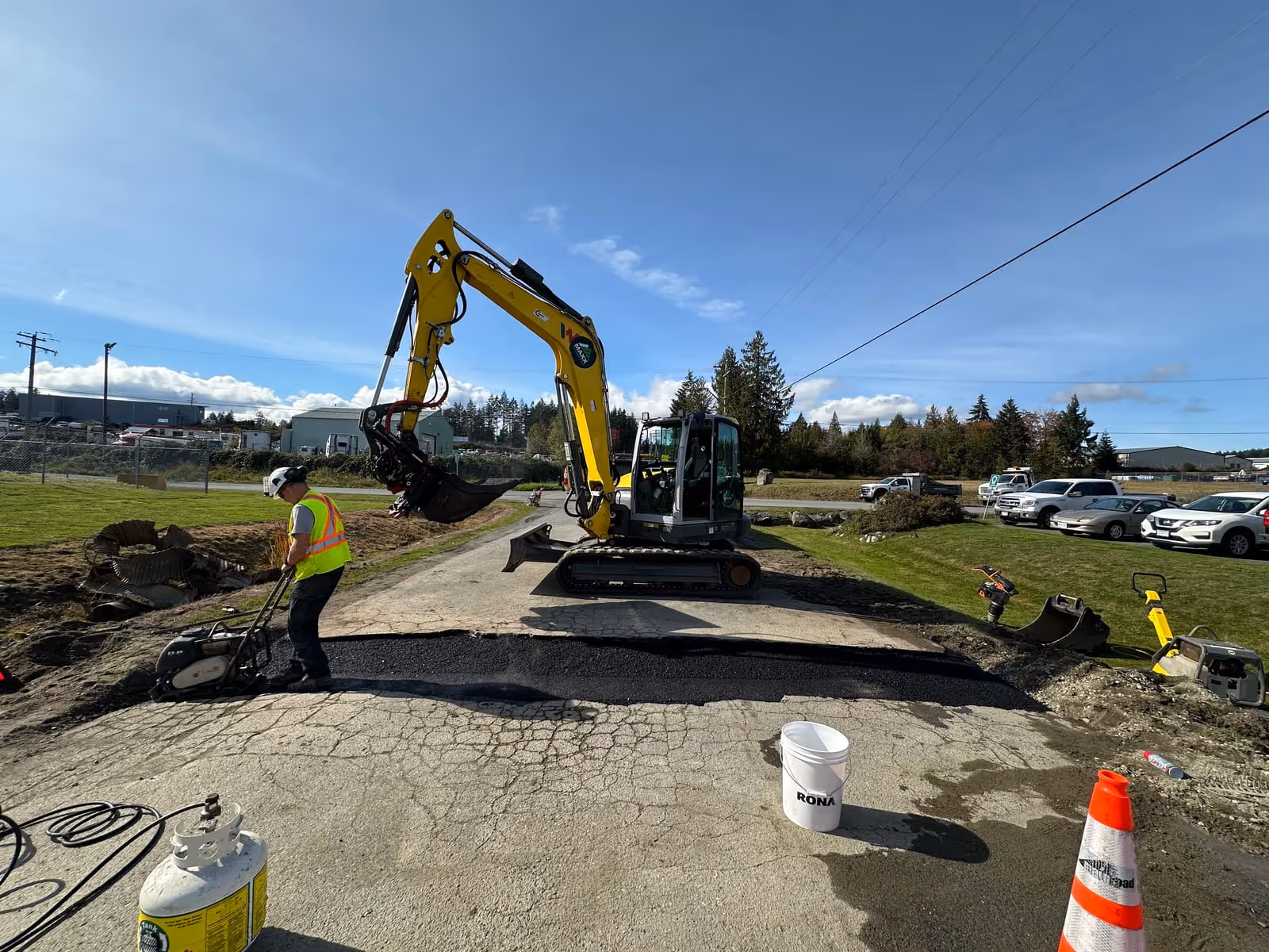 Excavator demolishing an old driveway