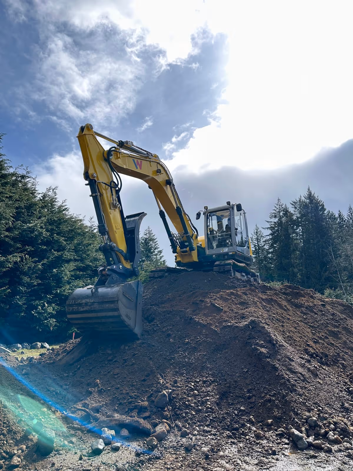 Excavator working on a dirt mound