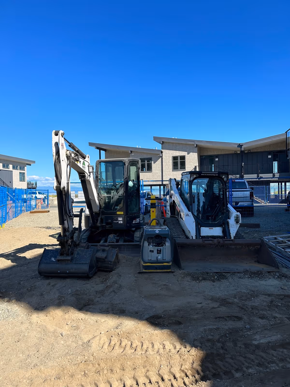 Excavators at a commercial construction site on Vancouver Island