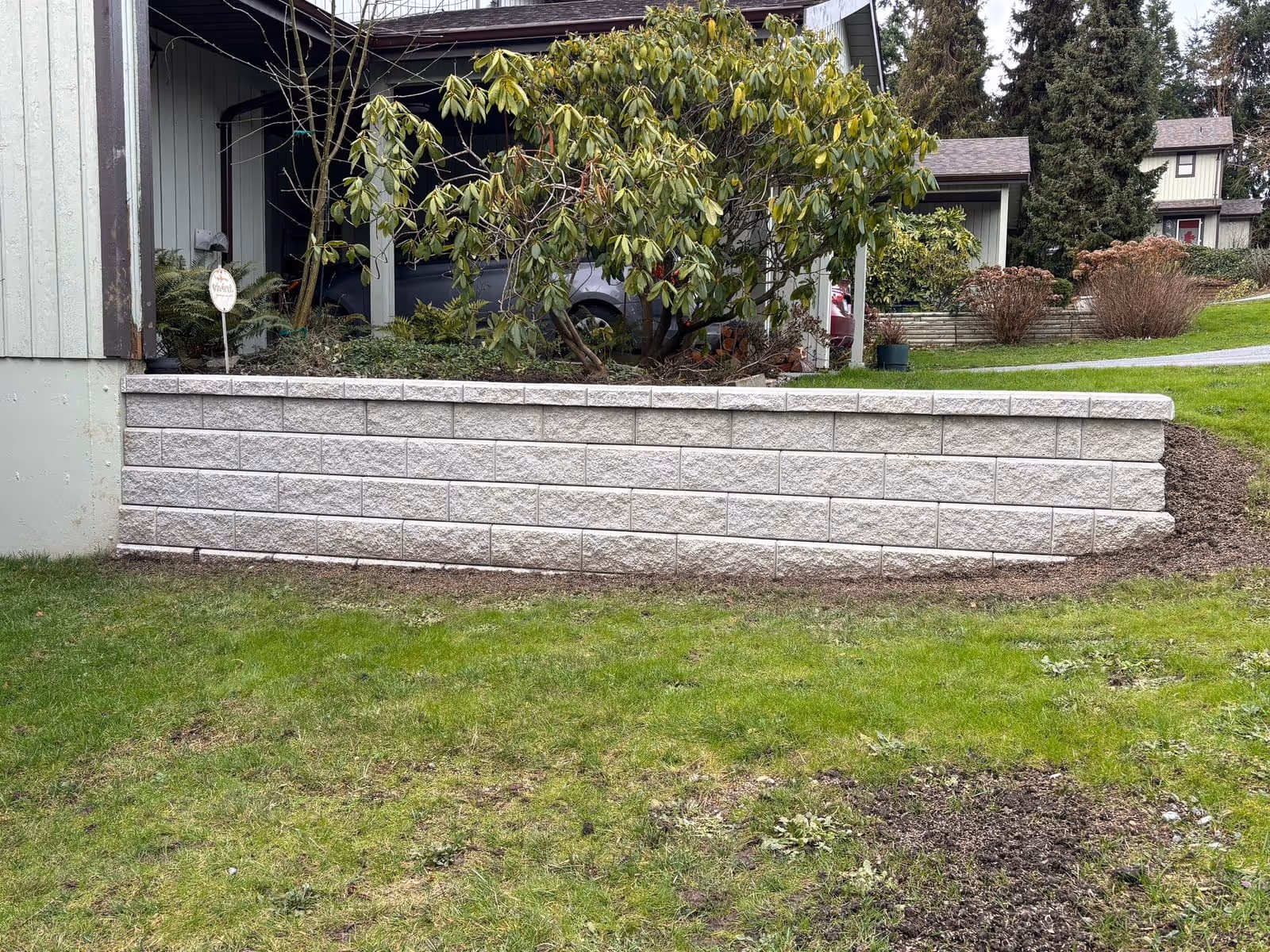 Cream block retaining wall in a Nanaimo front yard