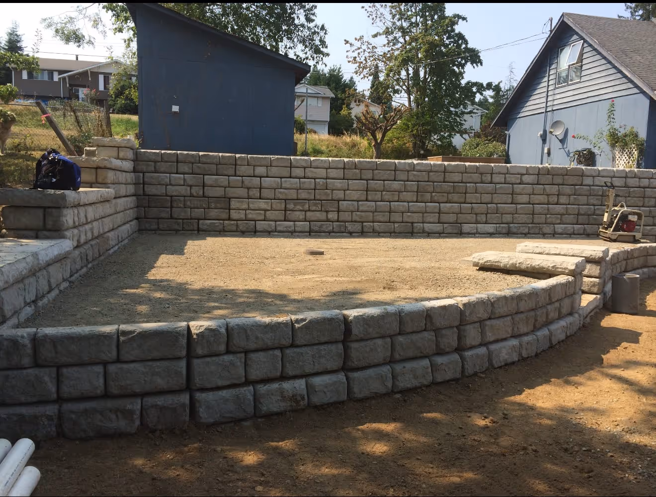 Large light block retaining wall under construction